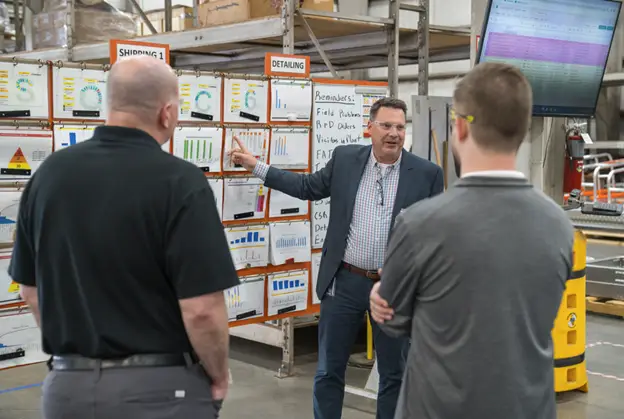 Jason Merschat leads the OpExChange tour of SixAxis to showcase the Lean Daily Management system